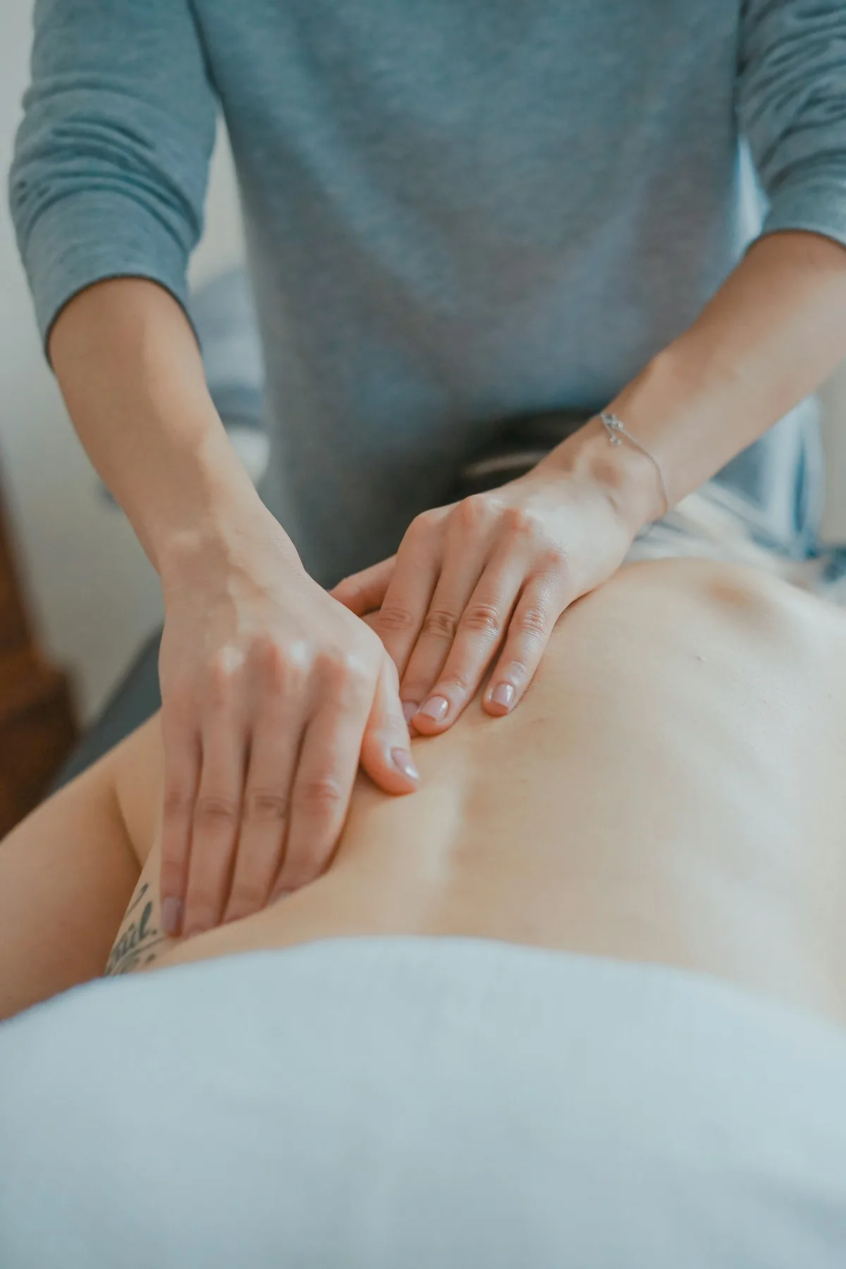 Therapist performing a back massage