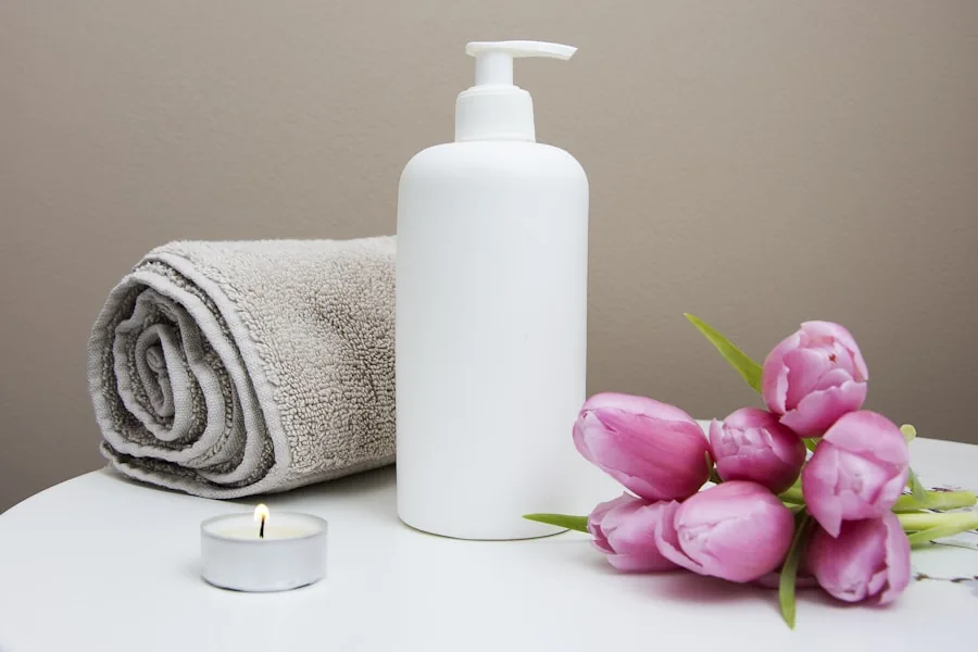 Treatment oil, rolled towel and a lit candle