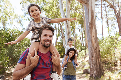 Family outdoors, an image used by Lonsdale Dental Centre