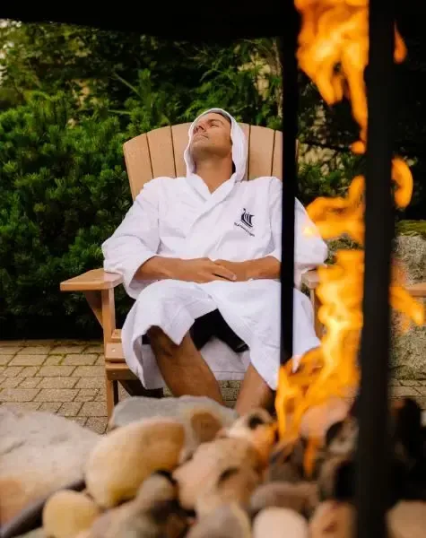 Guest resting by the outdoor fire